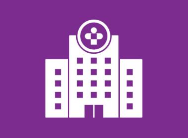 Icon of a hospital in white on a purple background