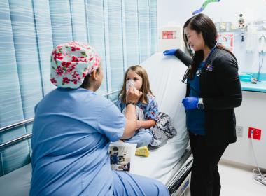 Team member interacting with a patient in pre-op.