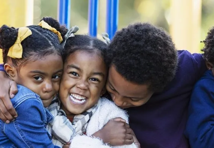 family hugging on a playscape