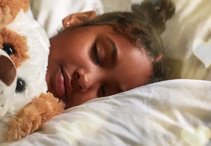 Girl sleeping with a teddy bear