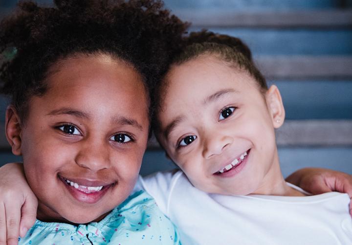 Two young children smile