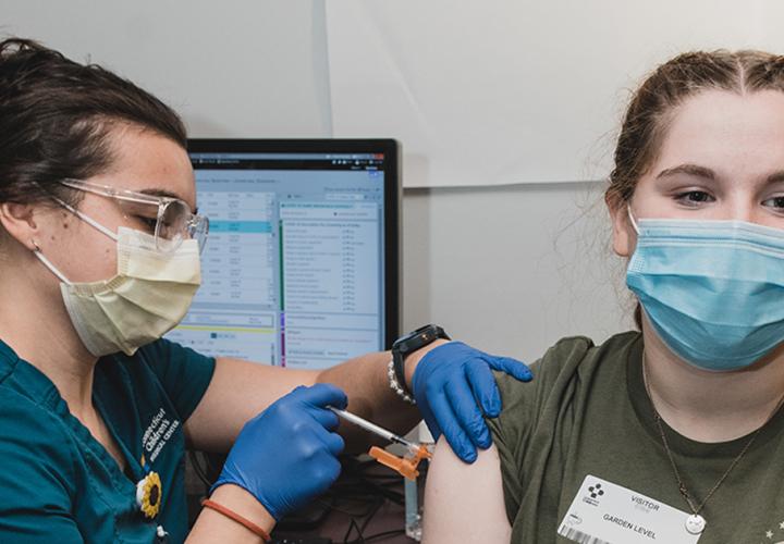 A teen getting a flu shot