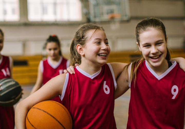 2 young teens on a basketball court