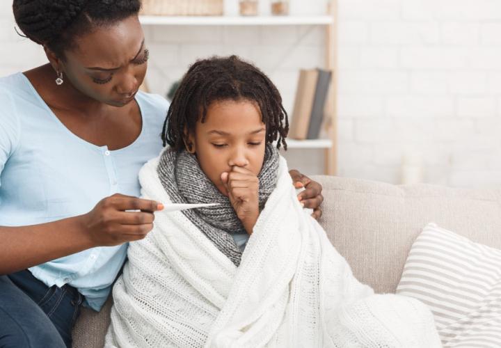 Mother measuring daughters temperature