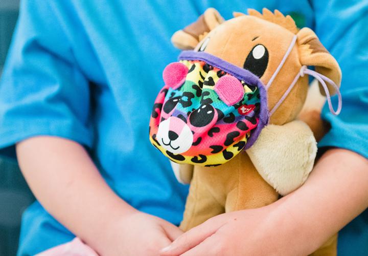 A child holds a stuffed animal