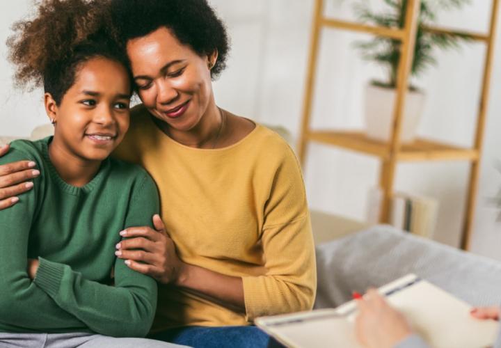 Mother and teenager daughter talk with therapist
