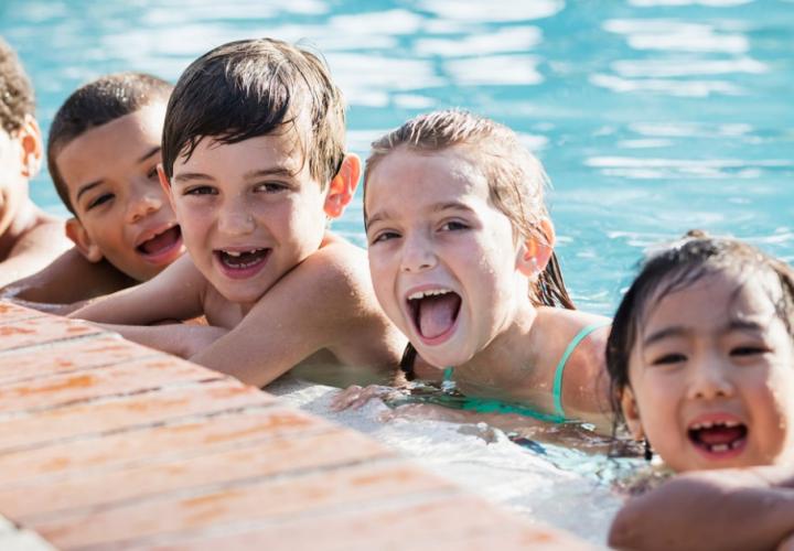 Young children playing in a pool