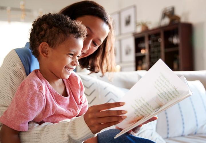 A mother reads a book with her son