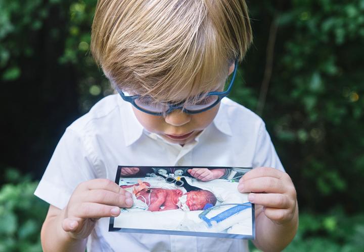 Jack holding his baby picture