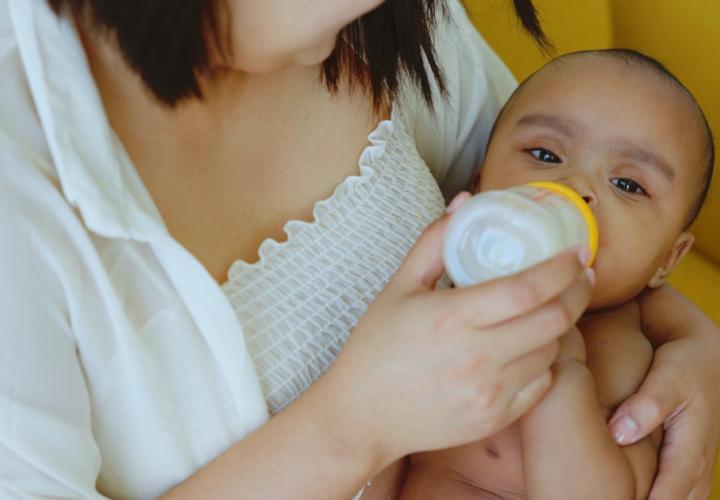 A mother giving her baby a bottle