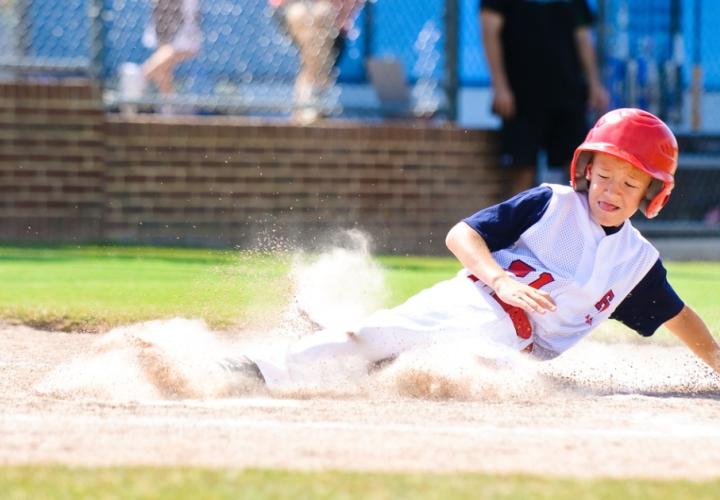 Boy sliding in baseball