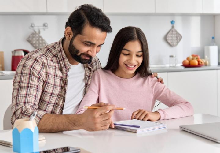 A father helping his daughter with homework