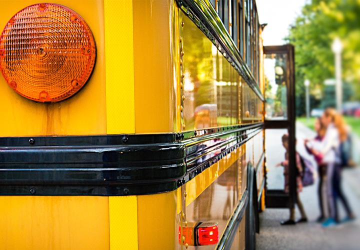 Kids getting on a school bus
