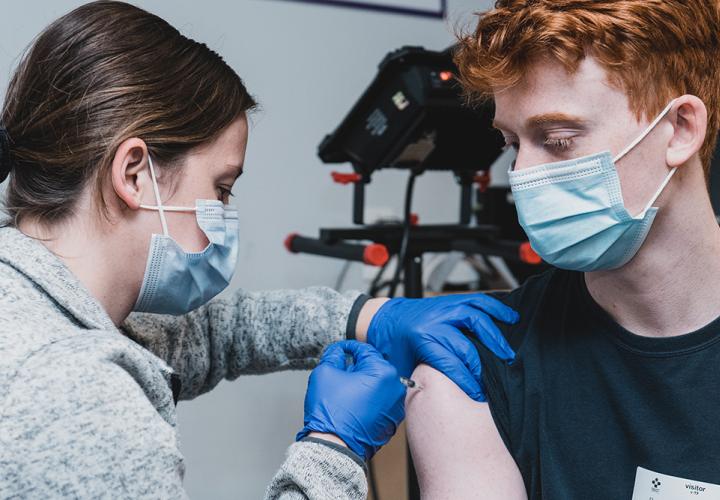 Teen getting a COVID vaccine