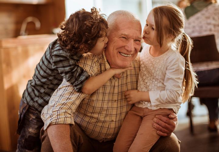 Two young children with their grandpa