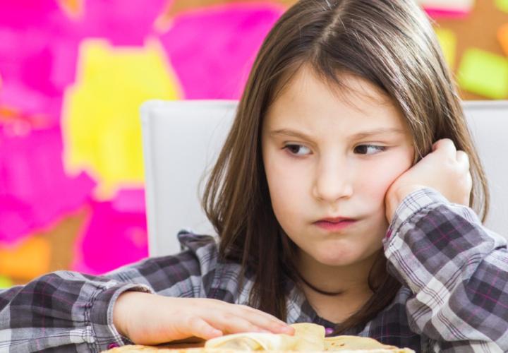 Young child indicating she's not hungry