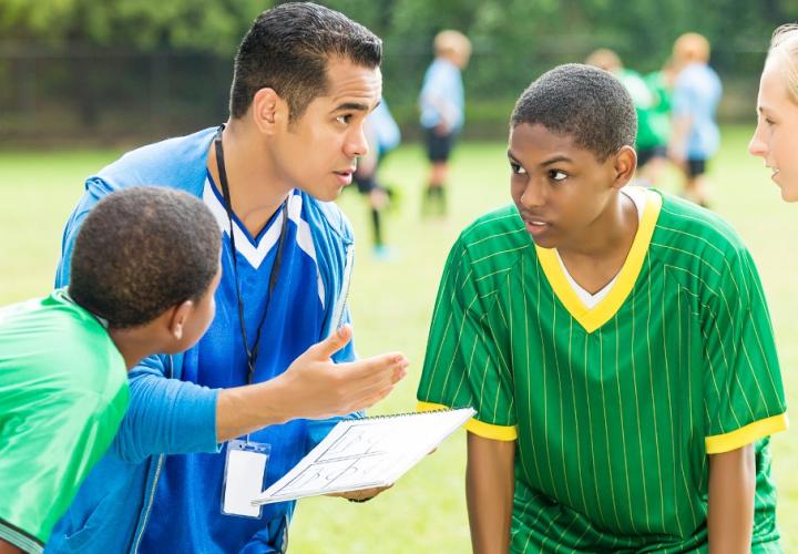 Coach talks to his players