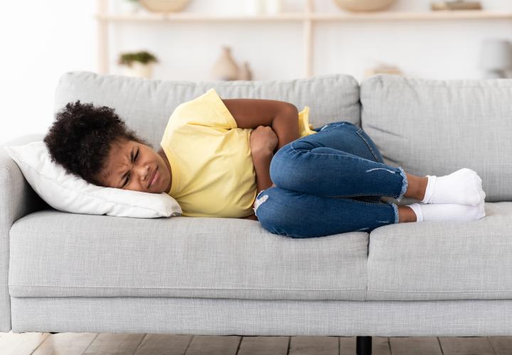 Girl with stomach pains on couch