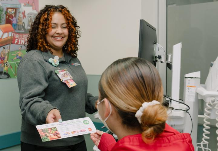 A patient being handed a food voucher in Connecticut Children's ED.
