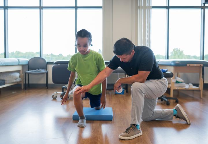 Athletic trainer working with a patient at our sports physical therapy location