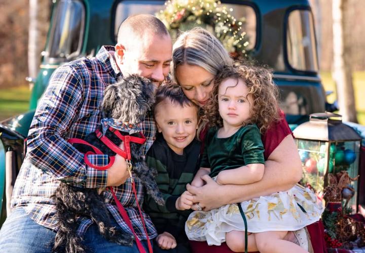 Young boy with little sister, mom, dad and dog