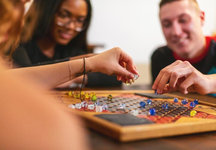 Teens playing a board game together