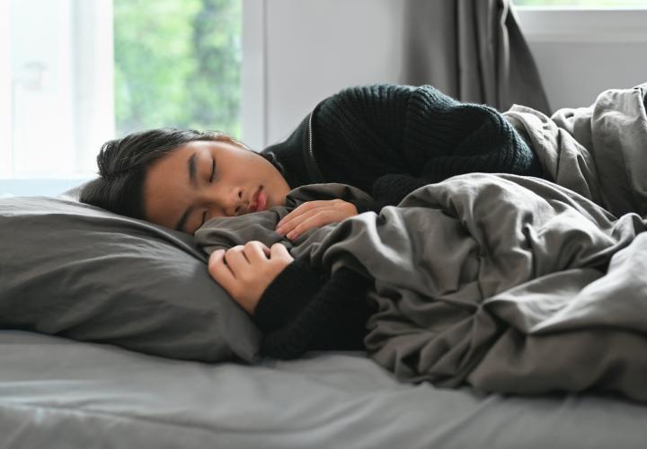 Teenage female sleeping. Athletic training and sleep together are important.
