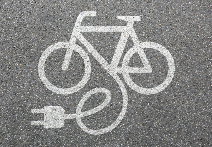 Chalk illustration of an electronic bike on pavement. E-bike injuries are rising fast