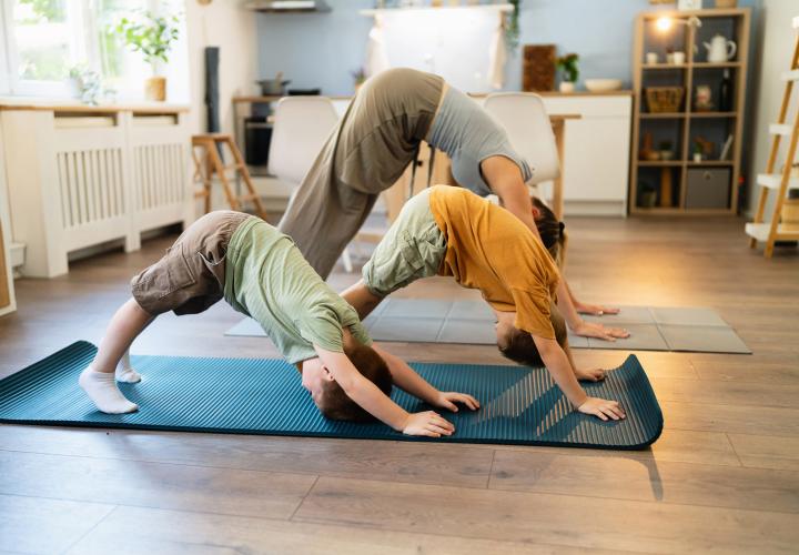 Family doing yoga together. 
