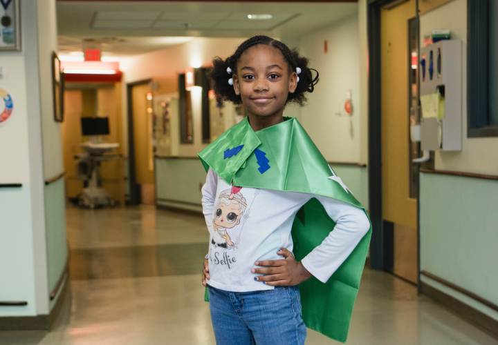 Girl in green cape Superhero Day