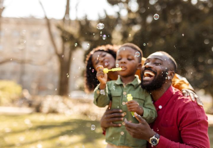 Family pblowing bubbles outside