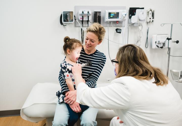 Dr. Wareham examines a patient in the ear, nose, and throat clinic at the Westport Specialty Care Center.