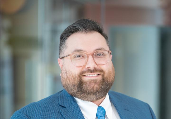 Man with short brown hair and glasses in blue business suit. Thomas Ricci, Chief Financial Officer, Connecticut Children's