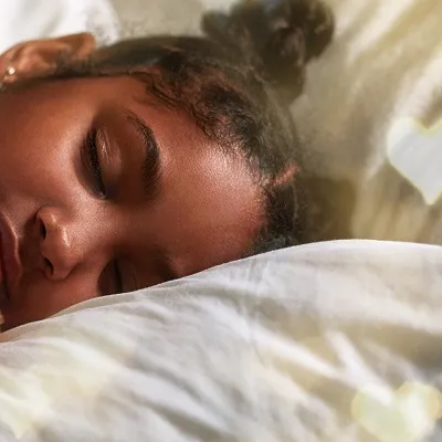 Girl sleeping with a teddy bear