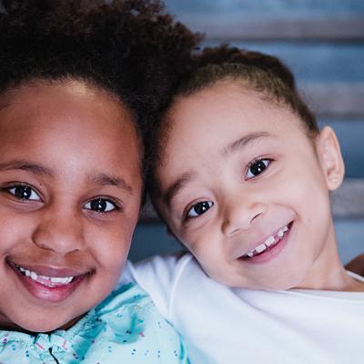 Two young children smile