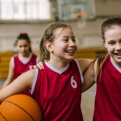 2 young teens on a basketball court
