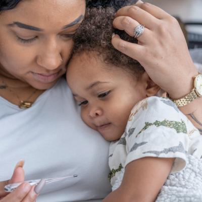 Mother snuggles her sick child