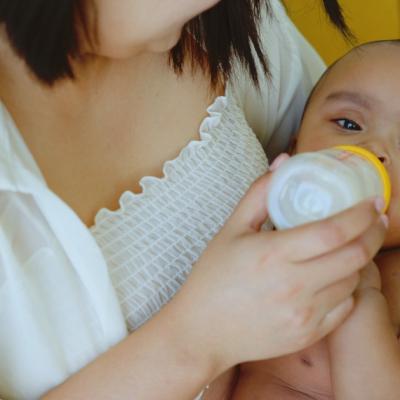 A mother giving her baby a bottle