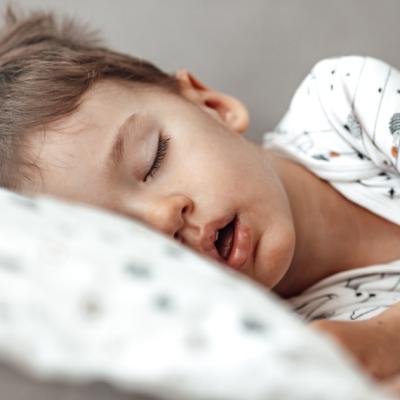 Young boy sleeping in bed