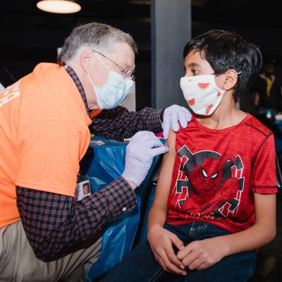 Young boy getting his COVID-19 vaccine