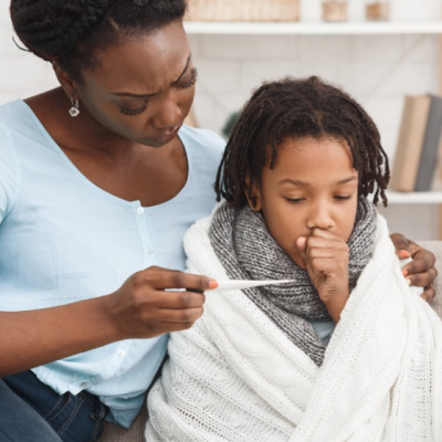 Mom taking her son's temperature, fever