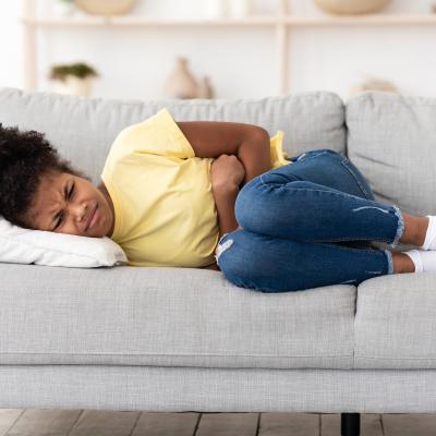 Girl with stomach pains on couch