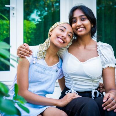 Two young adult female friends hugging