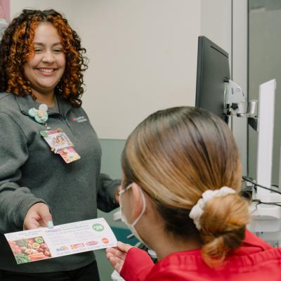 A patient being handed a food voucher in Connecticut Children's ED.