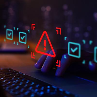 Laptop keyboard closeup with lit-up warning signs. Don't blow up Chromebooks at home