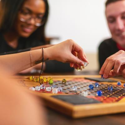 Teens playing a board game together