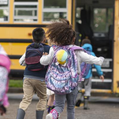 Kids getting on a school bus