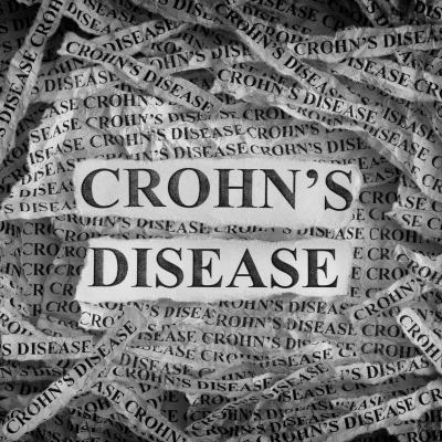 Torn pieces of paper with the words "Crohn's Disease"