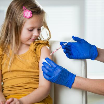 Young girl getting immunization in clinical setting