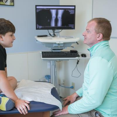 Provider treating Patient in Sports Medicine Department